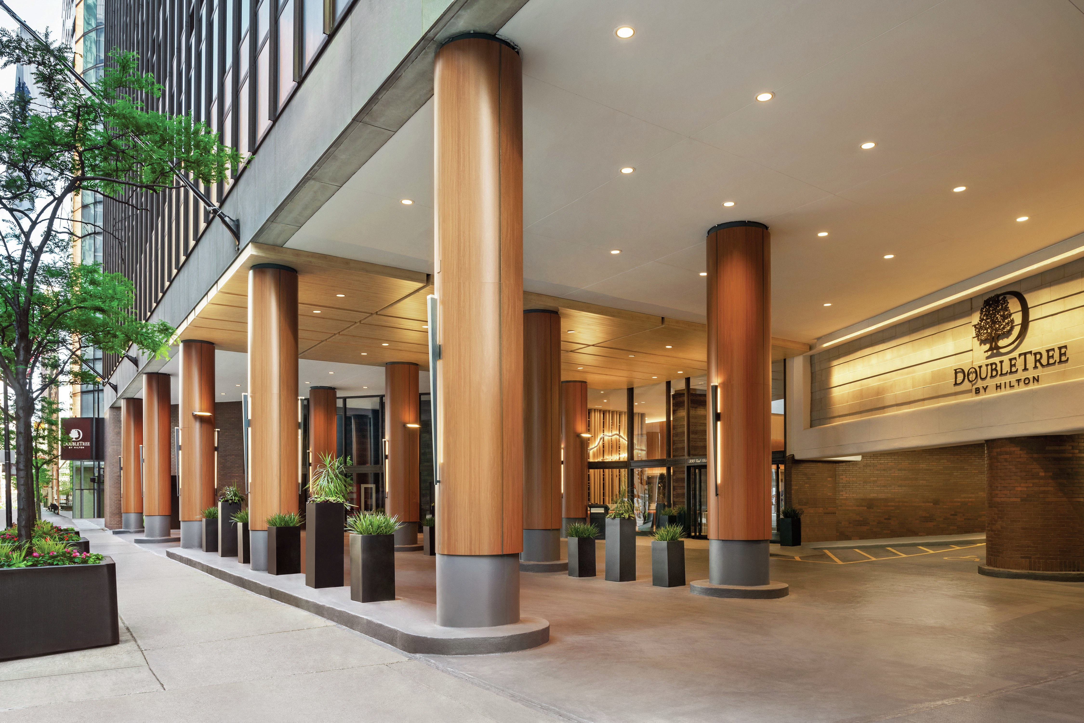 Hotel entrance with pillars and plants