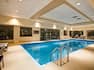 Indoor pool with handrail and seating