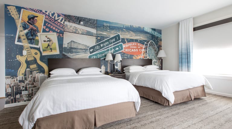 Two beds in room with lamps and curtains