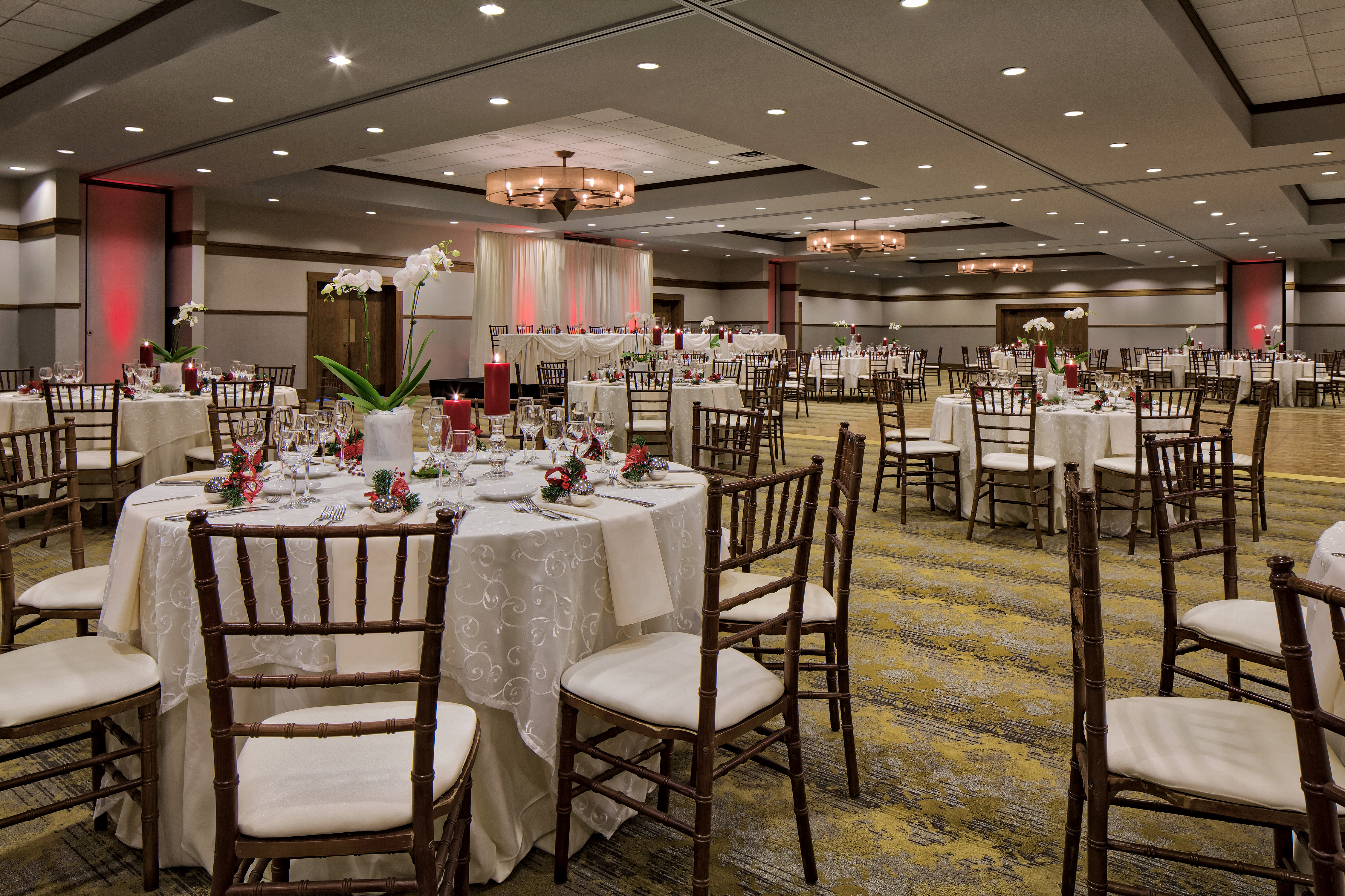 Spacious Ballroom Dining Setup with Round Tables and Chairs