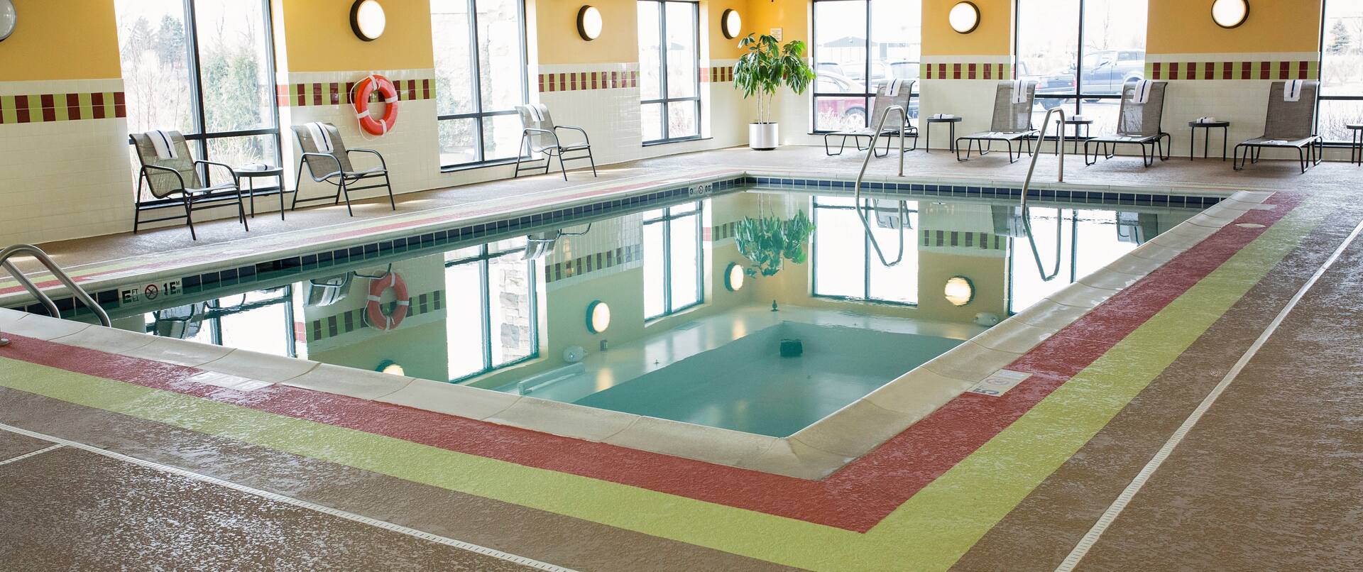 Indoor Swimming Pool Area with Tables and Chairs