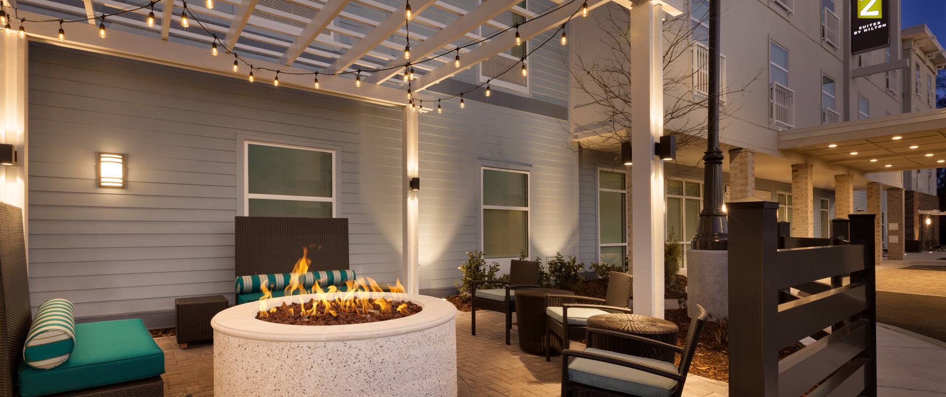 Outdoor Patio at Night with Lounge Chairs and Fire Pit