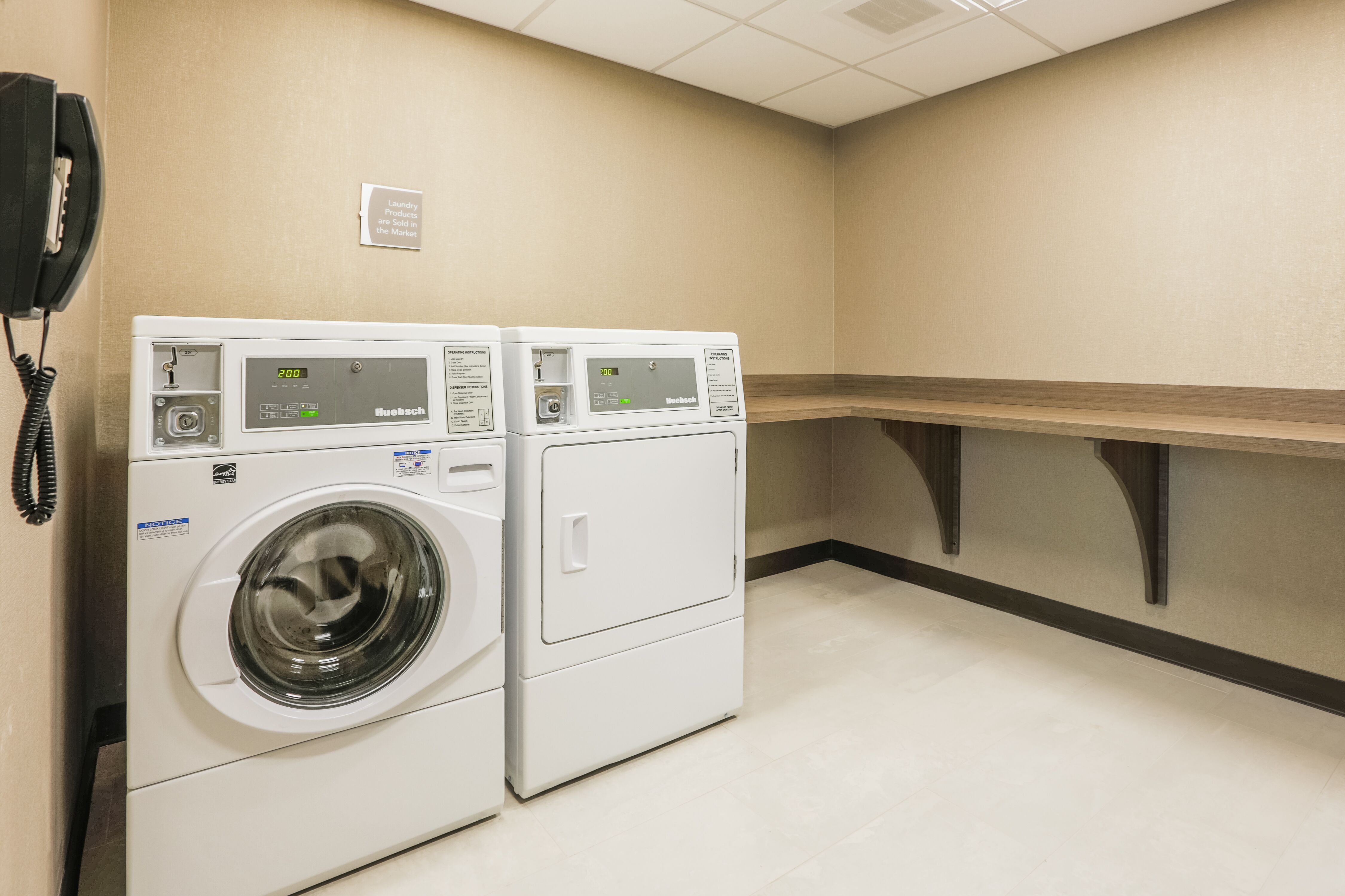 Guest Laundry Room with Wall Phone, Washer, Dryer and Wall Mounted Folding Table