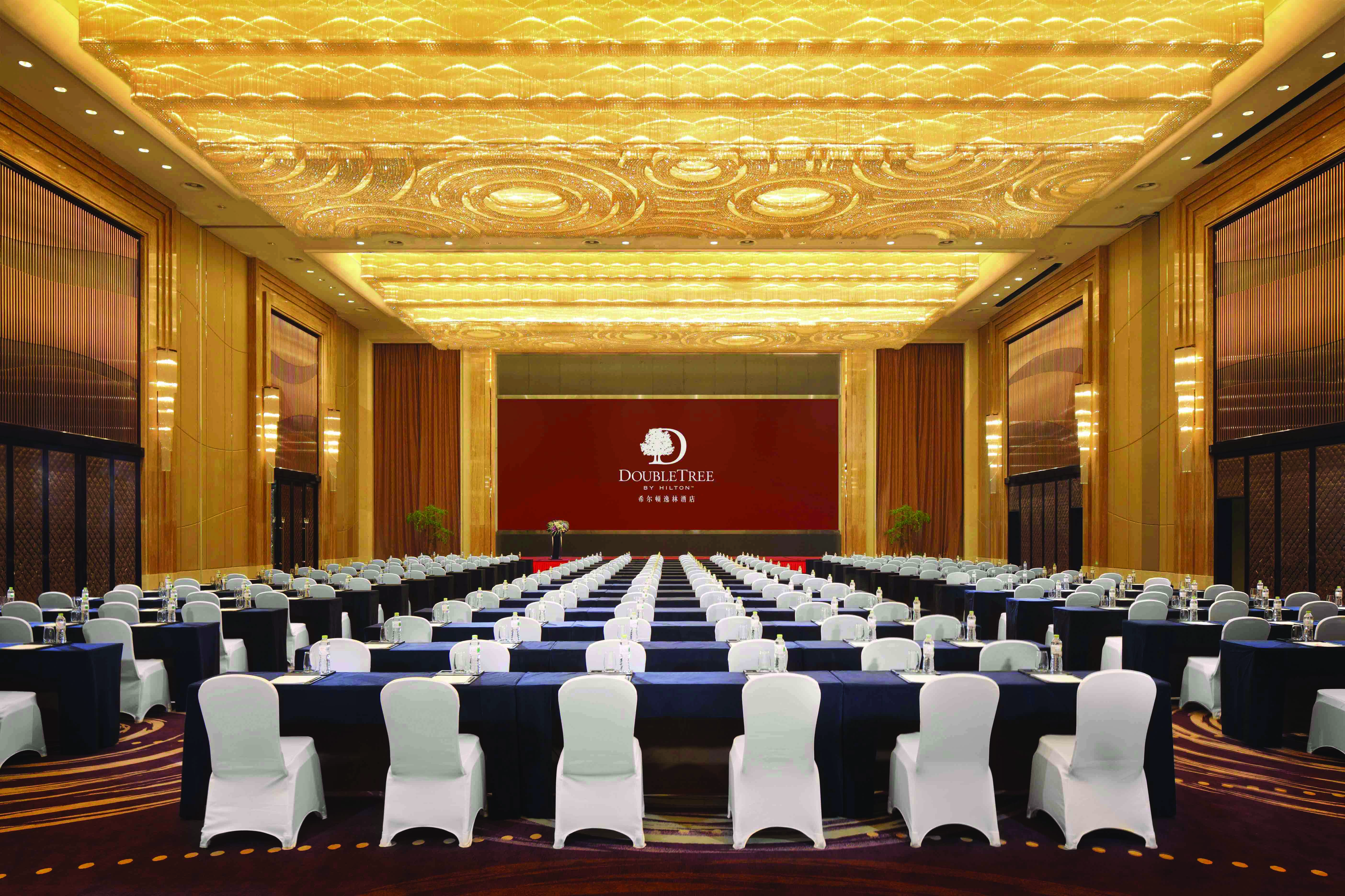 Banquet Hall with Tables and Chairs Facing Stage