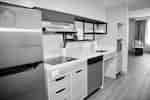 Kitchen area with full-size appliances in accessible suite.