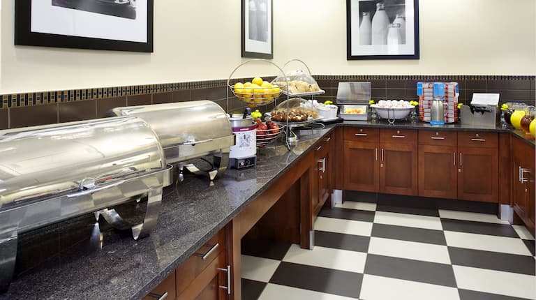Breakfast Buffet Area with Food Containers and Fruit Bowls