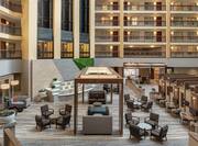 Spacious atrium in hotel featuring ample seating area, water features, and business centers.
