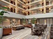 Spacious hotel atrium featuring ample seating, stylist decor, and inviting atmosphere.