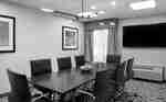 Meeting room with table, chairs and TV