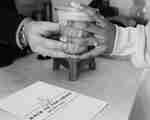 A cup of coffee being handed to customer at Back to the Grind Cafe