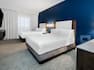 Two Queen Beds Guest Bedroom with Wall Mounted HDTV