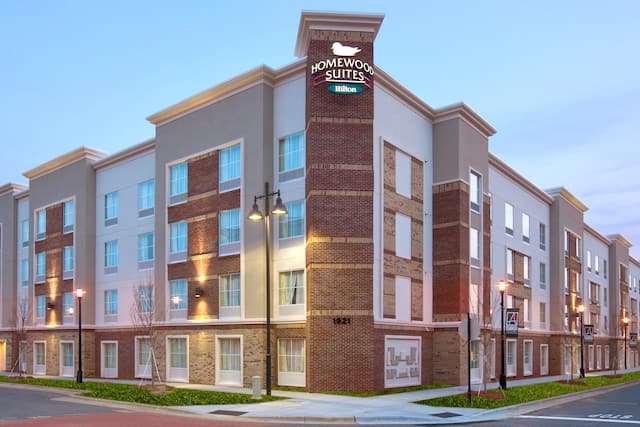 Illuminated Hotel Exterior With Signage at Dusk