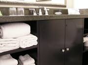 Bathroom Vanity With Fresh Towels, SInk, Toiletries, and Amenitites