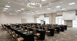 Hilton Garden Inn Meeting Room with Table, Chairs, and Projection Screens