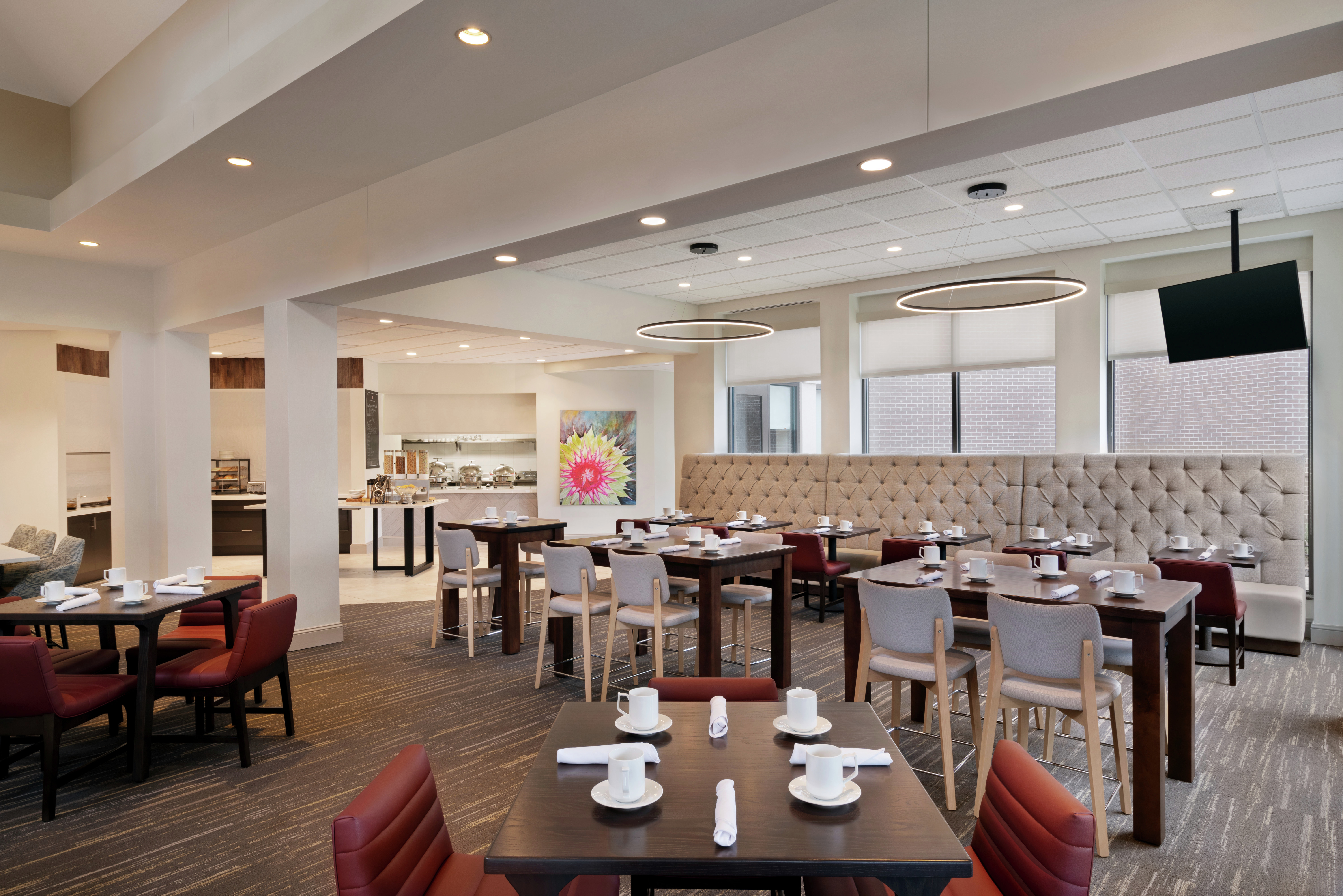 Hilton Garden Inn Restaurant with Tables, Chairs, and Room Technology