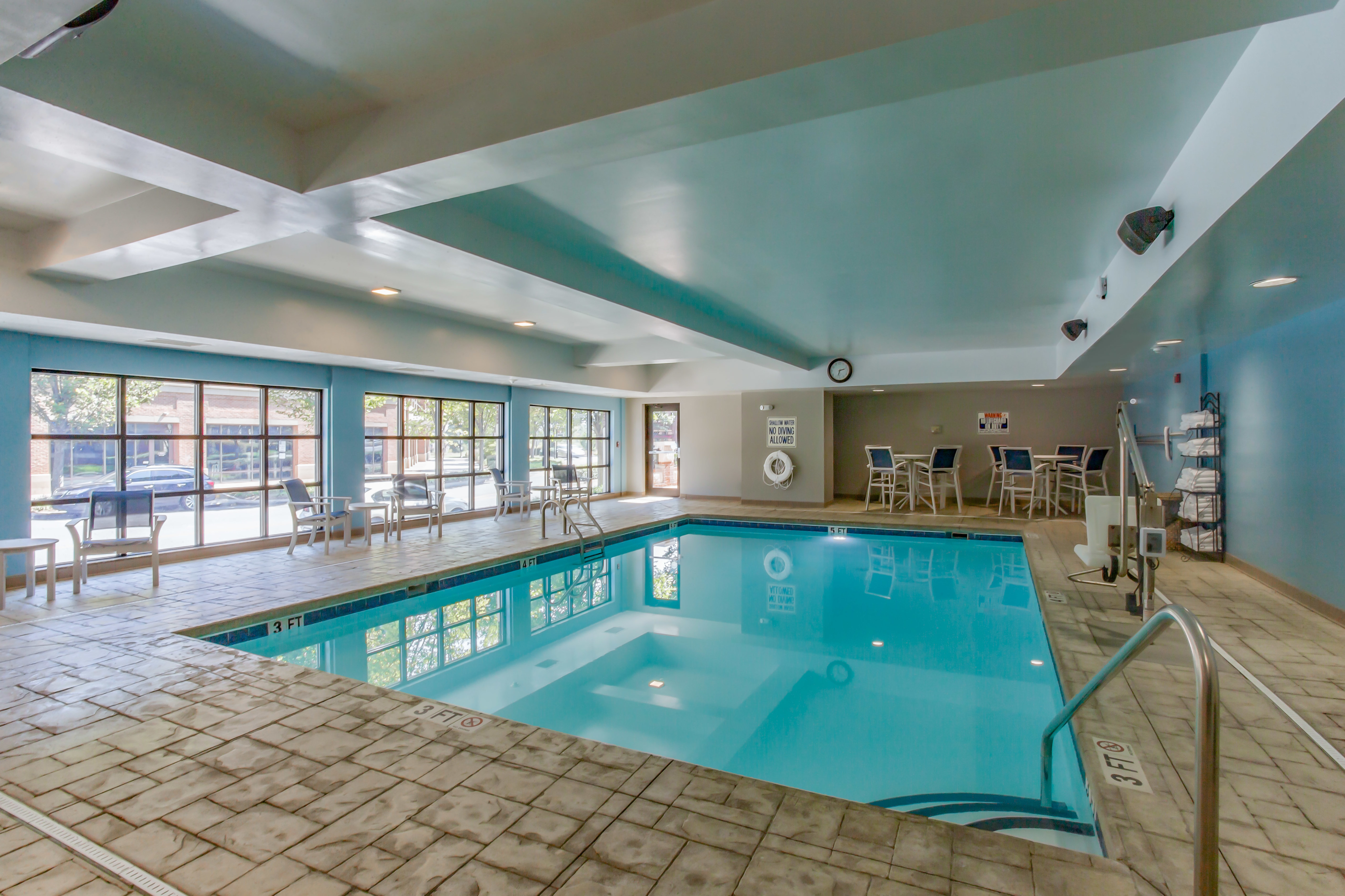Indoor Pool Area with Seating Area and Large Windows