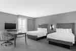 Double Queen Suite Guestroom With Work Desk and TV