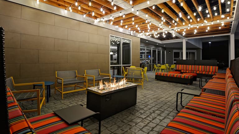 outdoor patio with firepit and seating at dusk