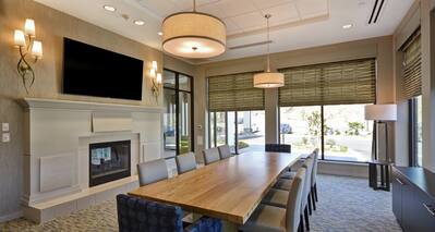 Large Table Fireplace and HDTV in Lobby Area
