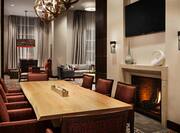 Interior Lobby Seating Area with Armchairs, Table, Fireplace and Wall Mounted HDTV