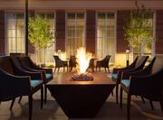 Outdoor Patio Fire Pit Area with Armchairs at Night