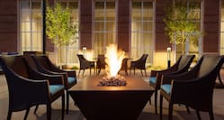 Outdoor Patio Fire Pit Area with Armchairs at Night