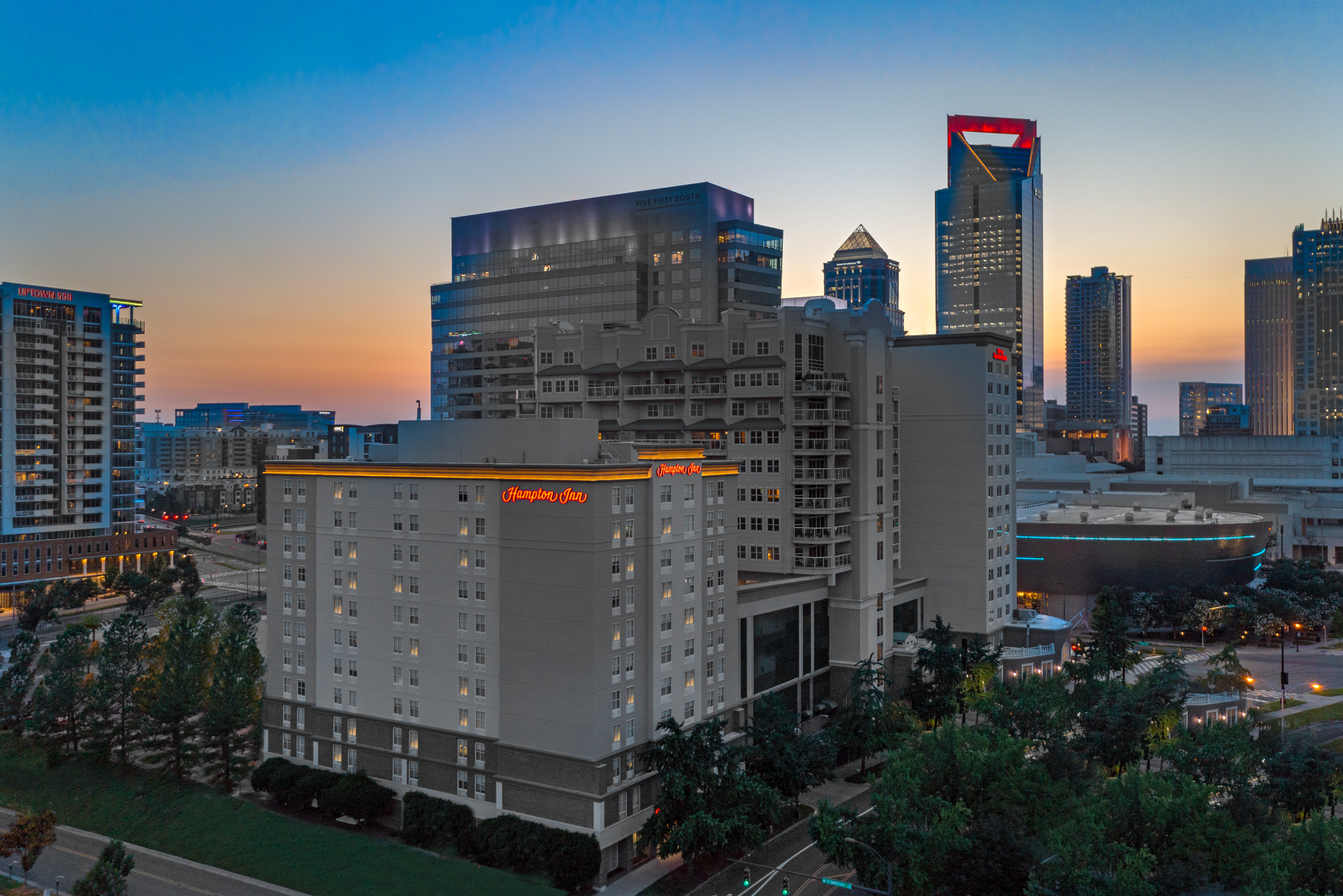 Hotel Exterior at dusk with surrounding buildings