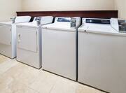 Row of Coin-Operated Washers and Dryers in Guest Laundry Room