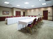 U-Shaped Table Setup and Chairs in Meeting Room