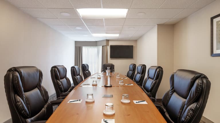Bright boardroom space featuring COVID setup to ensure guests health and safety.