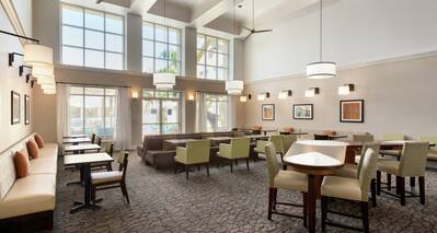Bright breakfast area seating featuring stylish design, coffered ceilings, and welcoming atmosphere. 