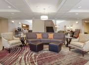 Welcoming hotel lobby featuring comfortable seating area, complimentary coffee station, and stylish design.