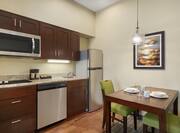 Bright living area in one bedroom suite featuring dining table, and fully equipped kitchen.