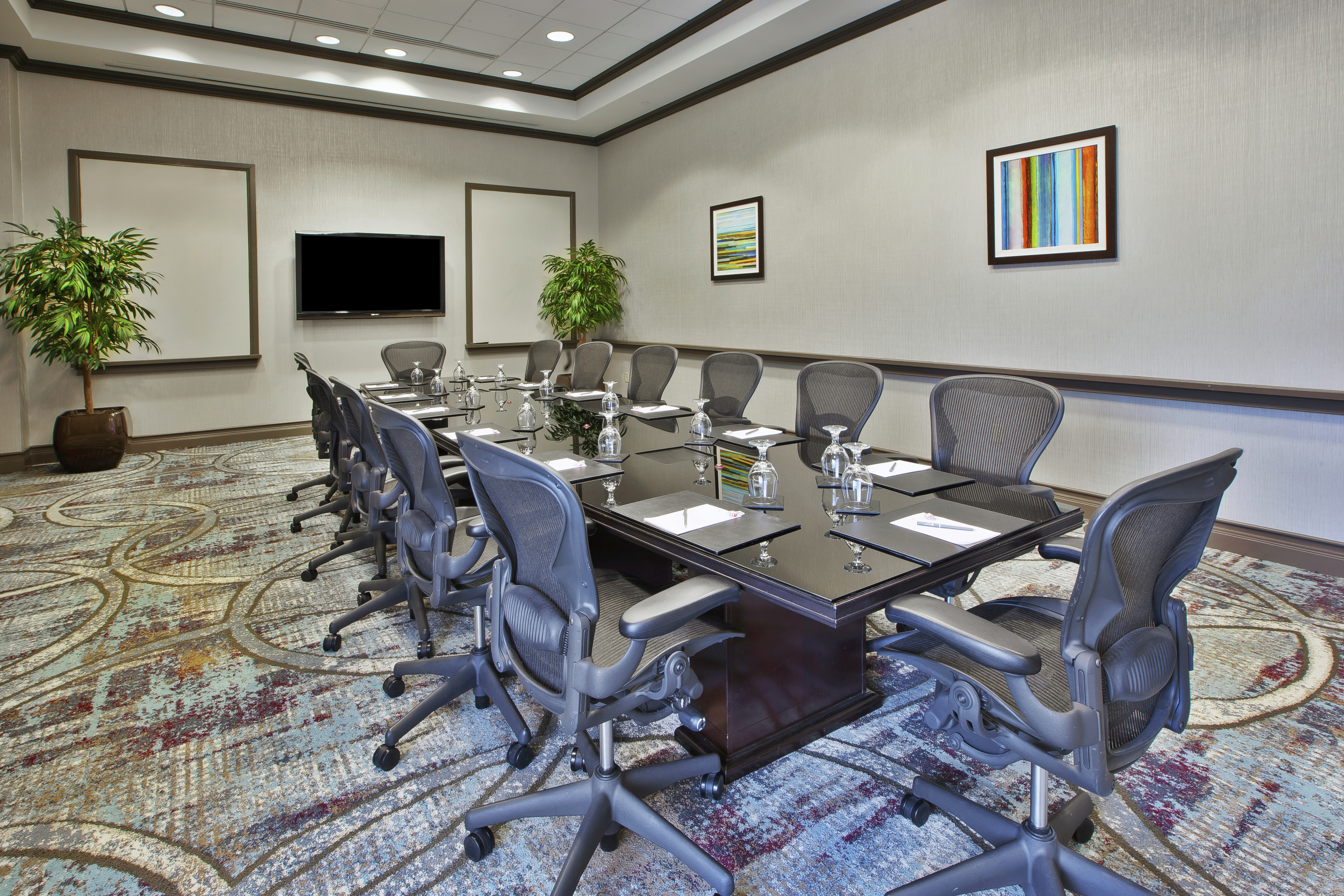 Tv Between Two White Boards, and Ergonomic Seating for 14 at Boardroom Table