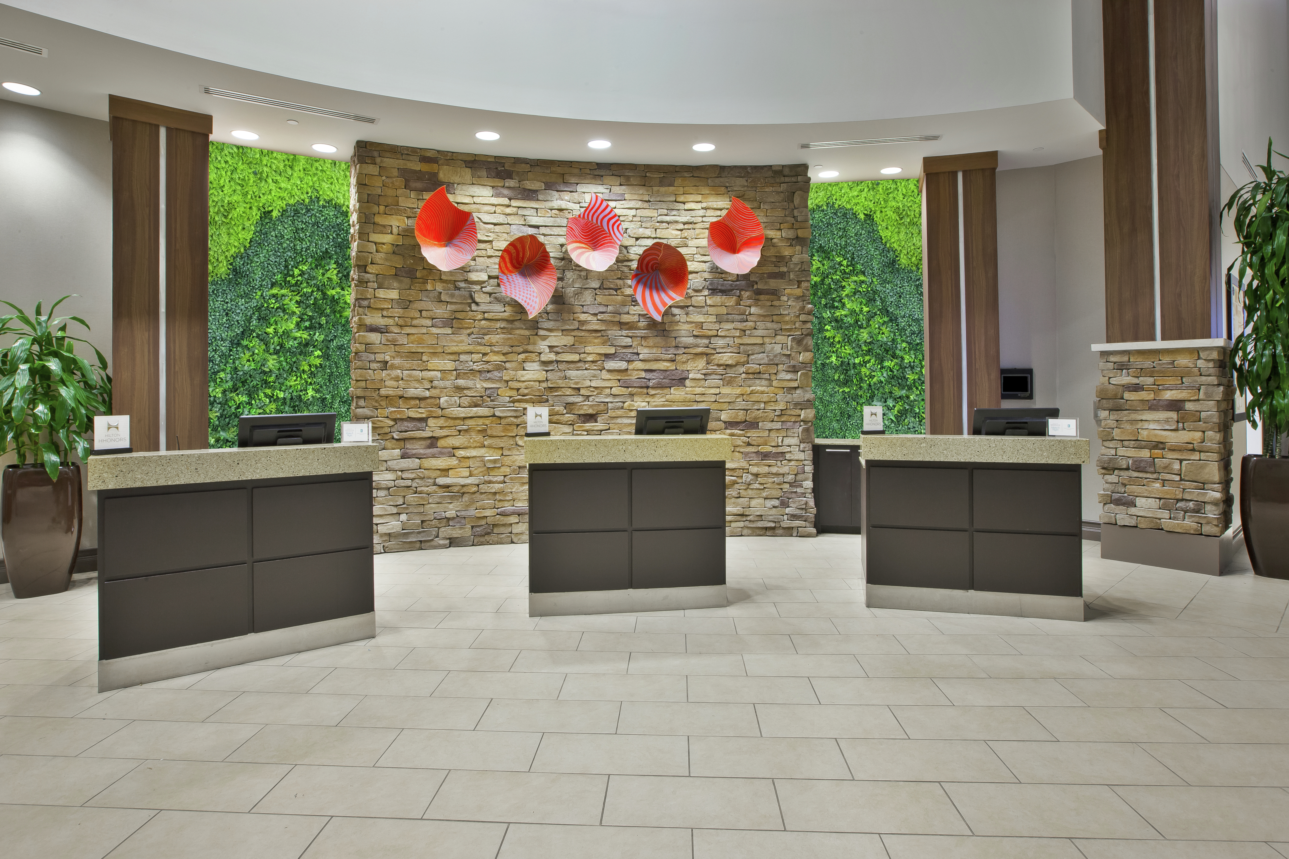 Colorful Art Features Behind Front Desk With Three Reception Stations