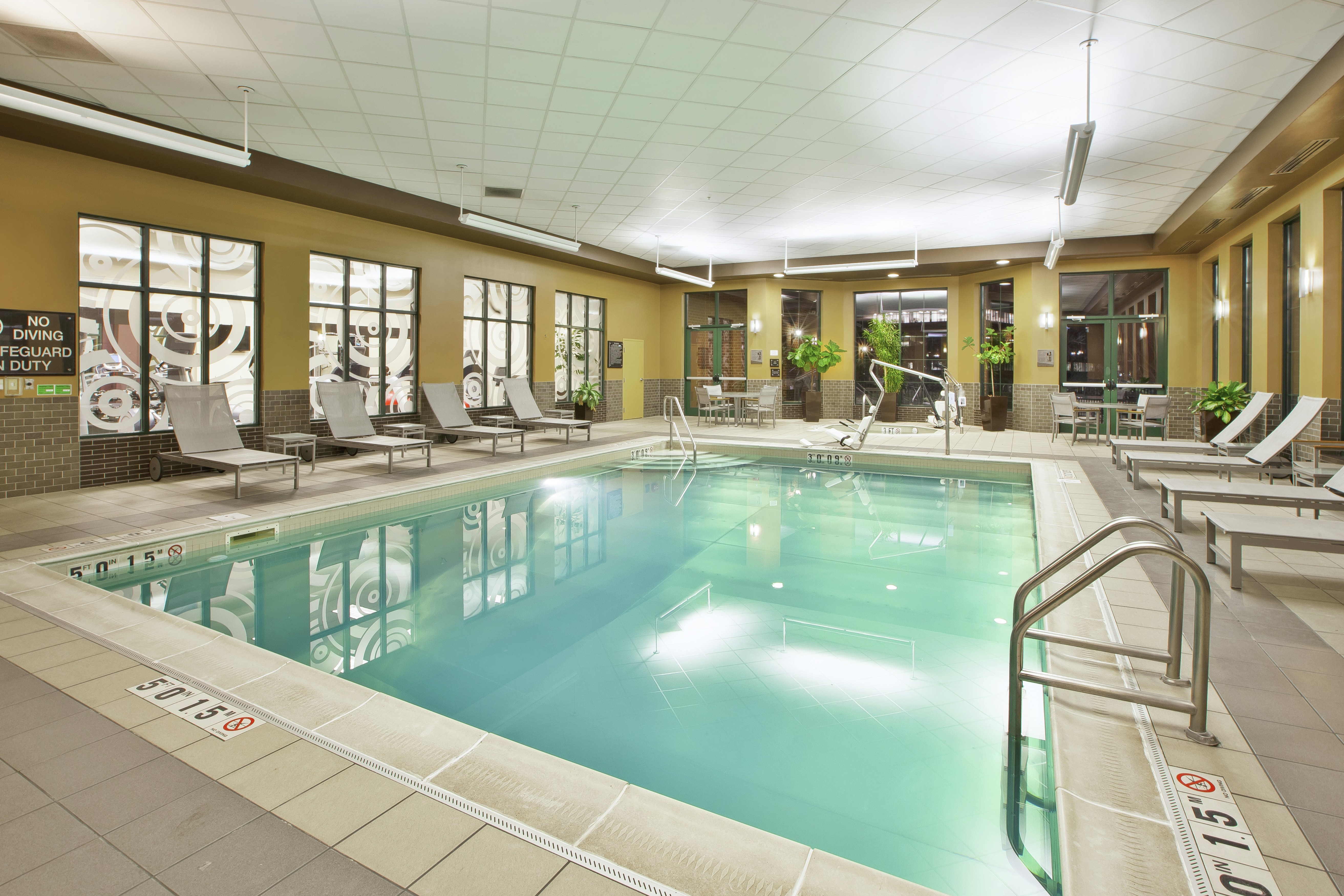 Relaxation Loungers and Windows by Indoor Pool