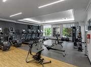Fitness center with exercise machines, exercise balls, and windows with outdoor view