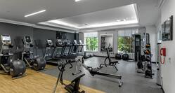 Fitness center with exercise machines, exercise balls, and windows with outdoor view