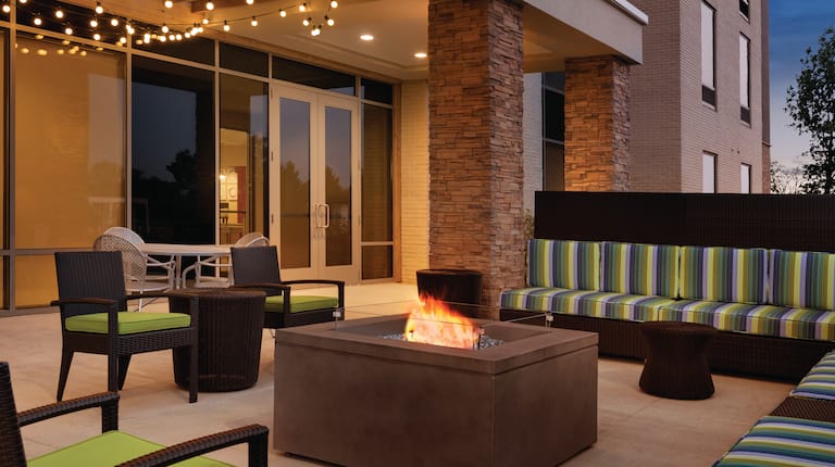 Outdoor Patio Fire Pit Area with Chairs and Sofas