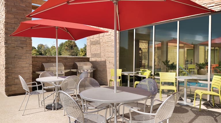 Outdoor Patio Area with Tables, Seats and Umbrellas