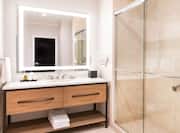 Vanity Area and Glassdoor Shower in Hotel Guest Room