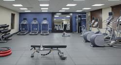 Fitness Center with Weight Bench, Treadmills, Cross-Trainers and Dumbbell Rack