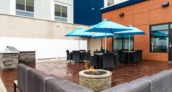 Firepit and Outdoor Seating Area in Patio with a Grill
