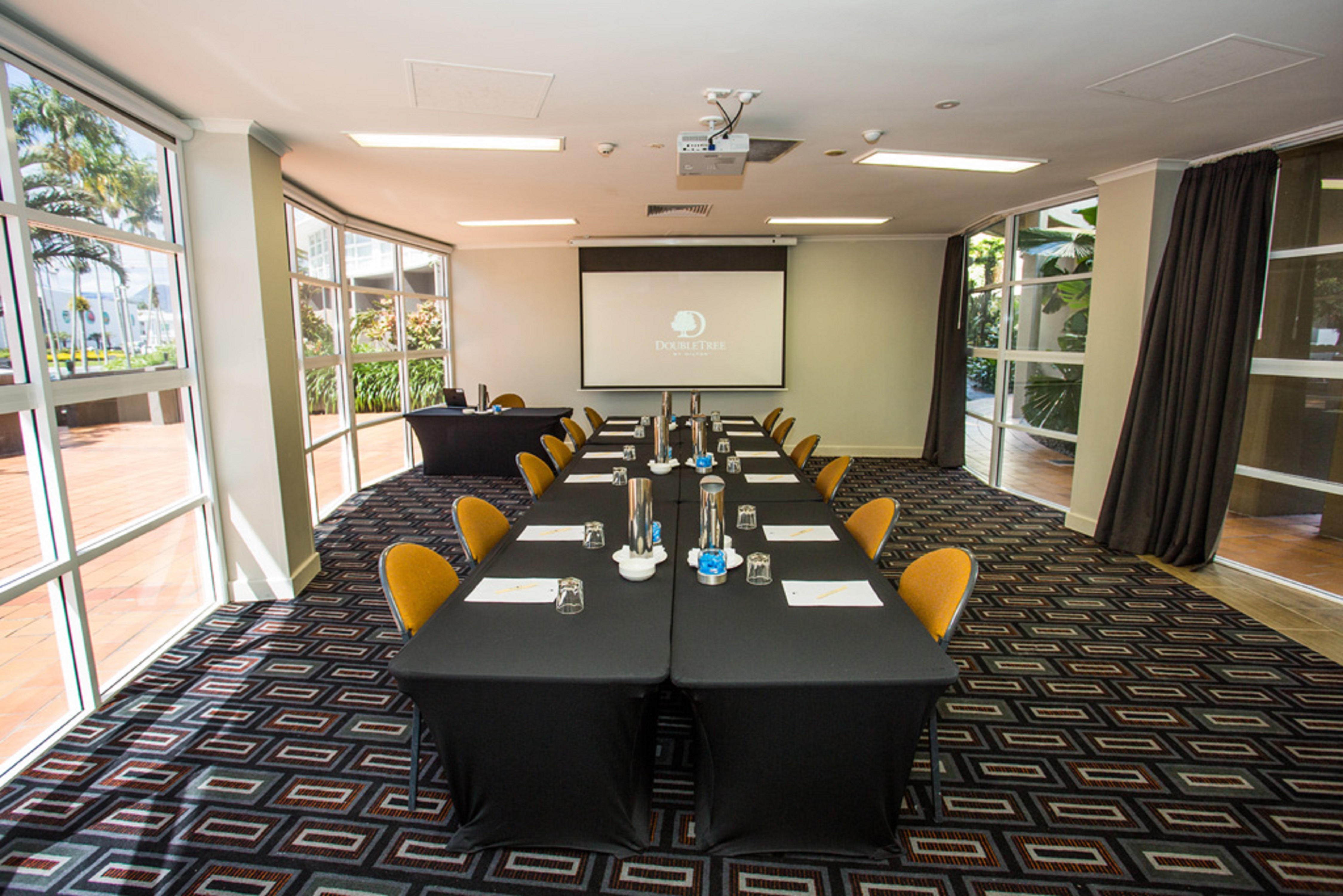 Meeting Room with Tables, Chairs and Projector Screen