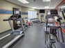 Fitness Room with Treadmill Recumbent Bike and Weights 
