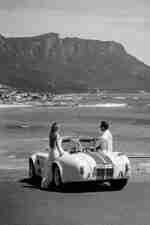 Two people viewing sea from vintage Cobra