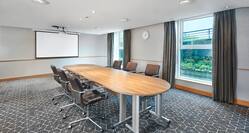 Boardroom with Conference Table, Projector Screen and Outside View