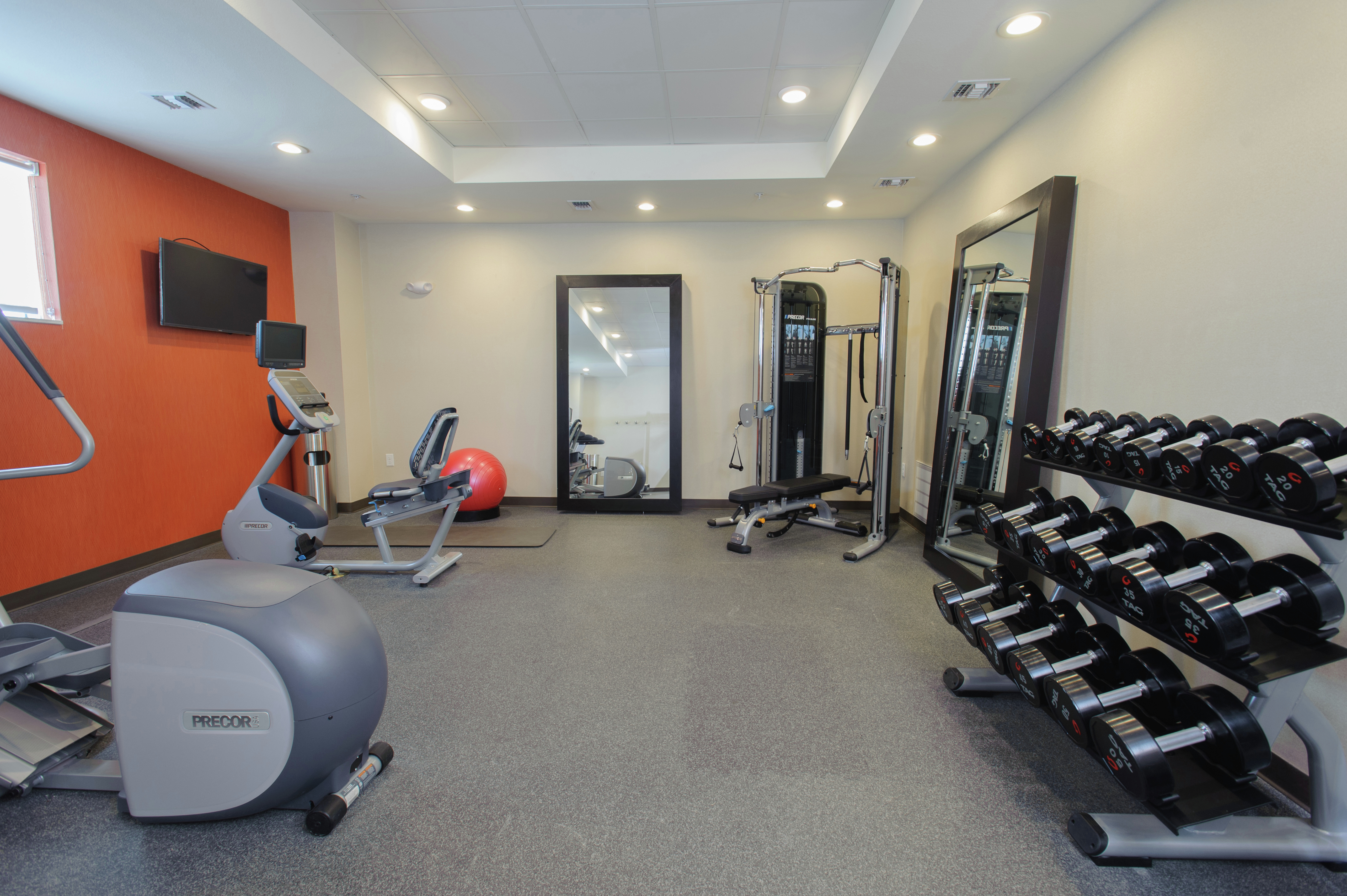 Fitness center with free weights and cardio machines.