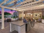 Outdoor Patio Area with BBQ Grills at Dusk