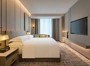 Guest Room with Luxurious Bed and Wall Television